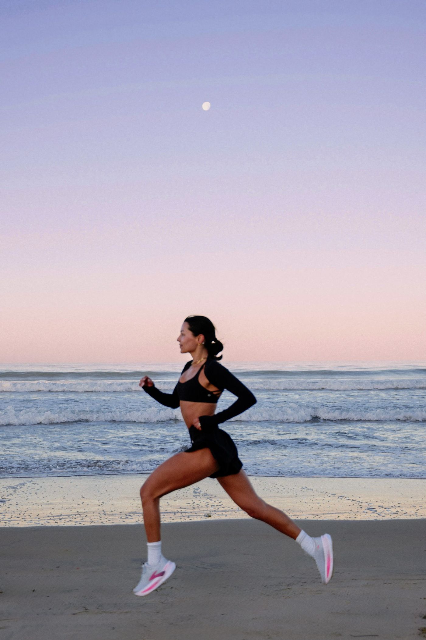 Meg running on the beach at dusk